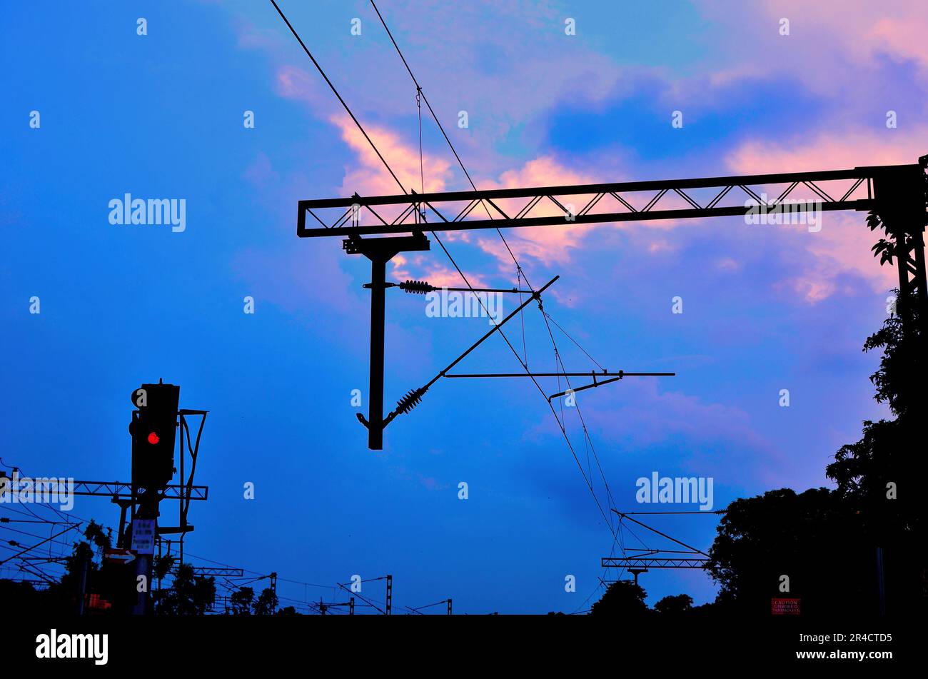Railway signal and electric wire and post in blue sky Stock Photo