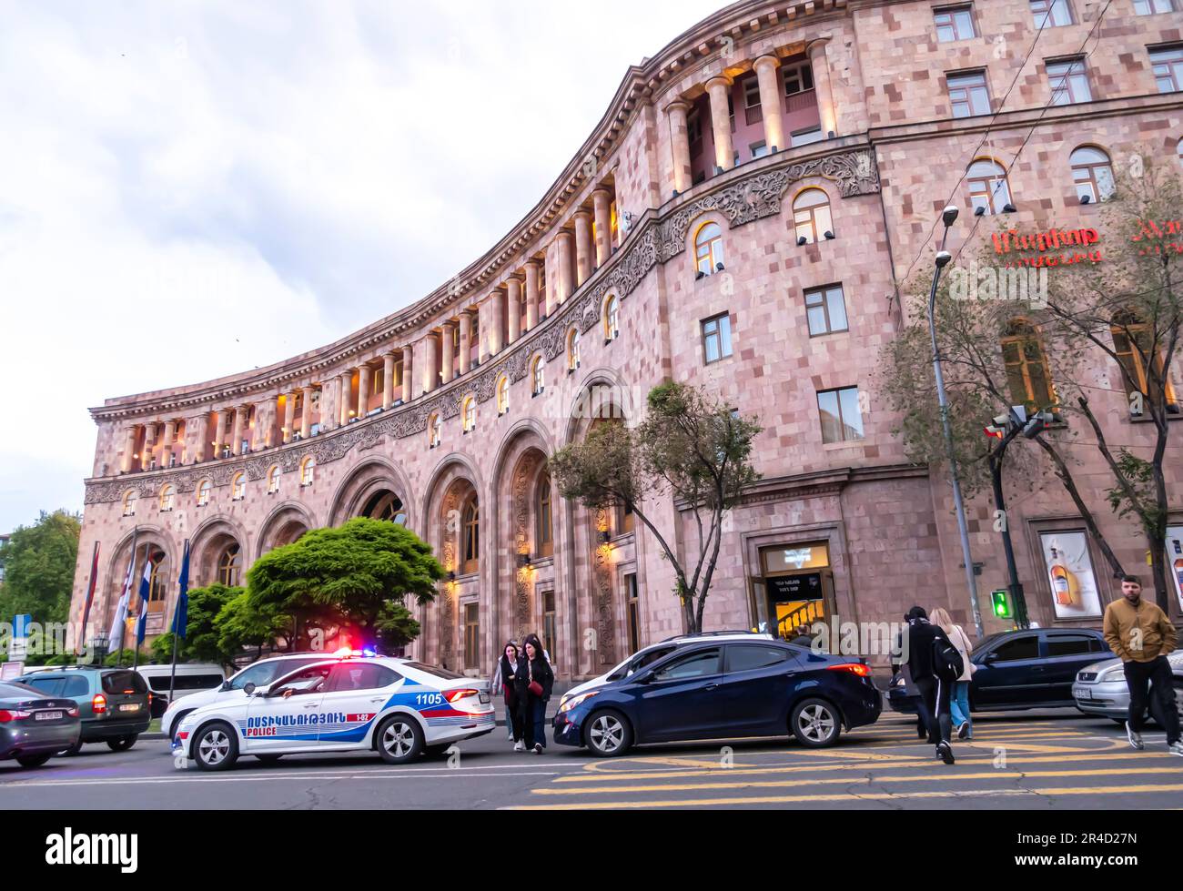 Armenia Marriott Hotel Yerevan. Young people crossing a road, police
