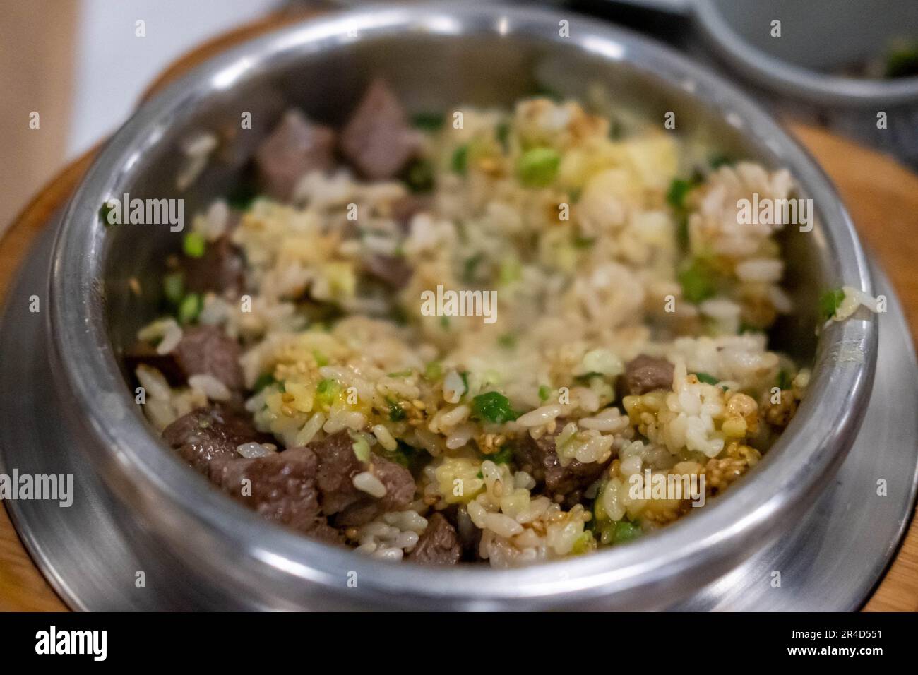 Beef steak rice in a steamed pot with egg. Korean food Stock Photo - Alamy