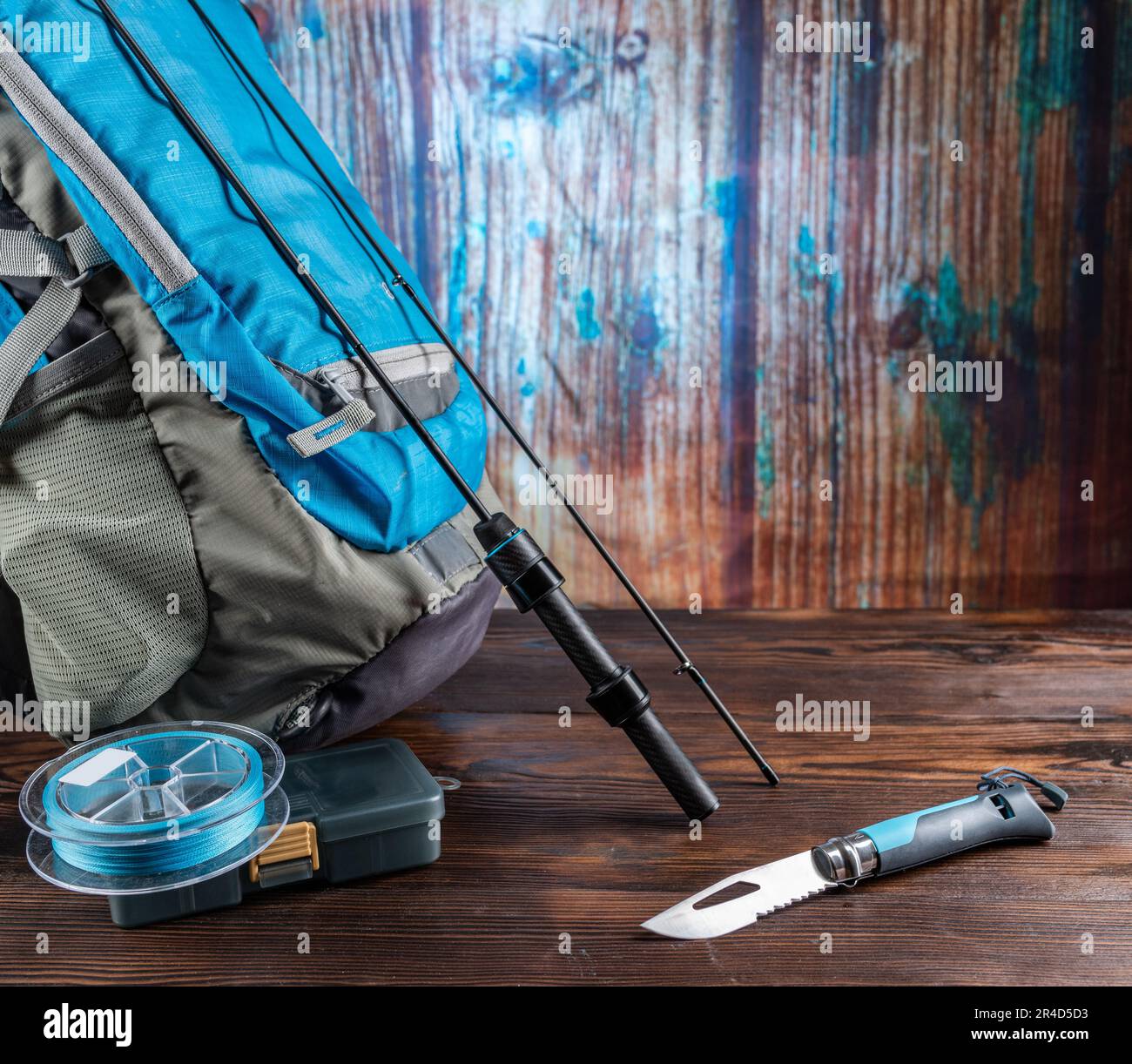 Tourist fisherman's set. Fishing rod and backpack. Fishing composition with  spinning and knife Stock Photo - Alamy