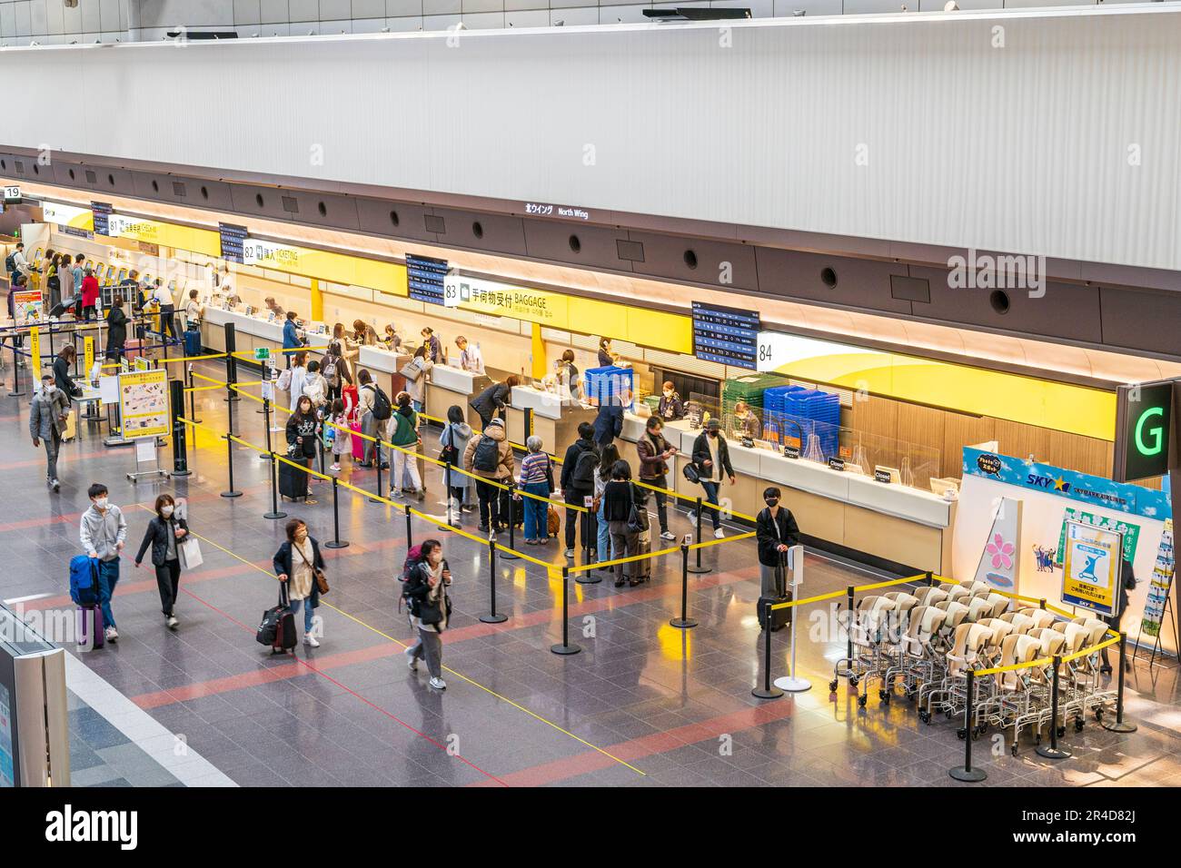 Overhead view of people queuing at the Skymark Airlines baggage check