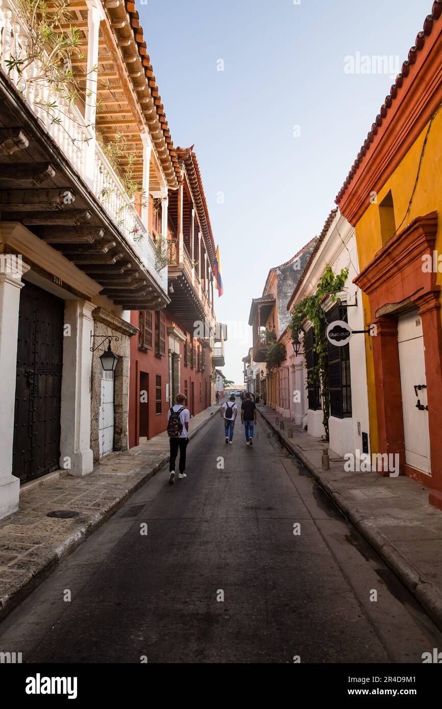 Looking down a street as people walk away in Cartagena Colombia Stock Photo