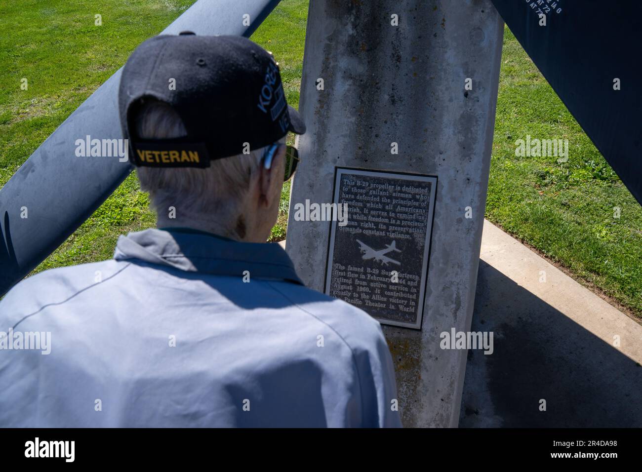 Retired Master Sgt. Eugene T. Beal reads a plaque at a B-29 Superfortress propeller display April 3, 2023, at Beale Air Force Base, California. Eugene spent most of his career as a boom operator in the KC-97 Stratofreighter and the KC-135 Stratotanker. Upon enlisting in March 1952, he was sent to fight in the Korean War as a tail gunner in the B-29 Superfortress. Stock Photo