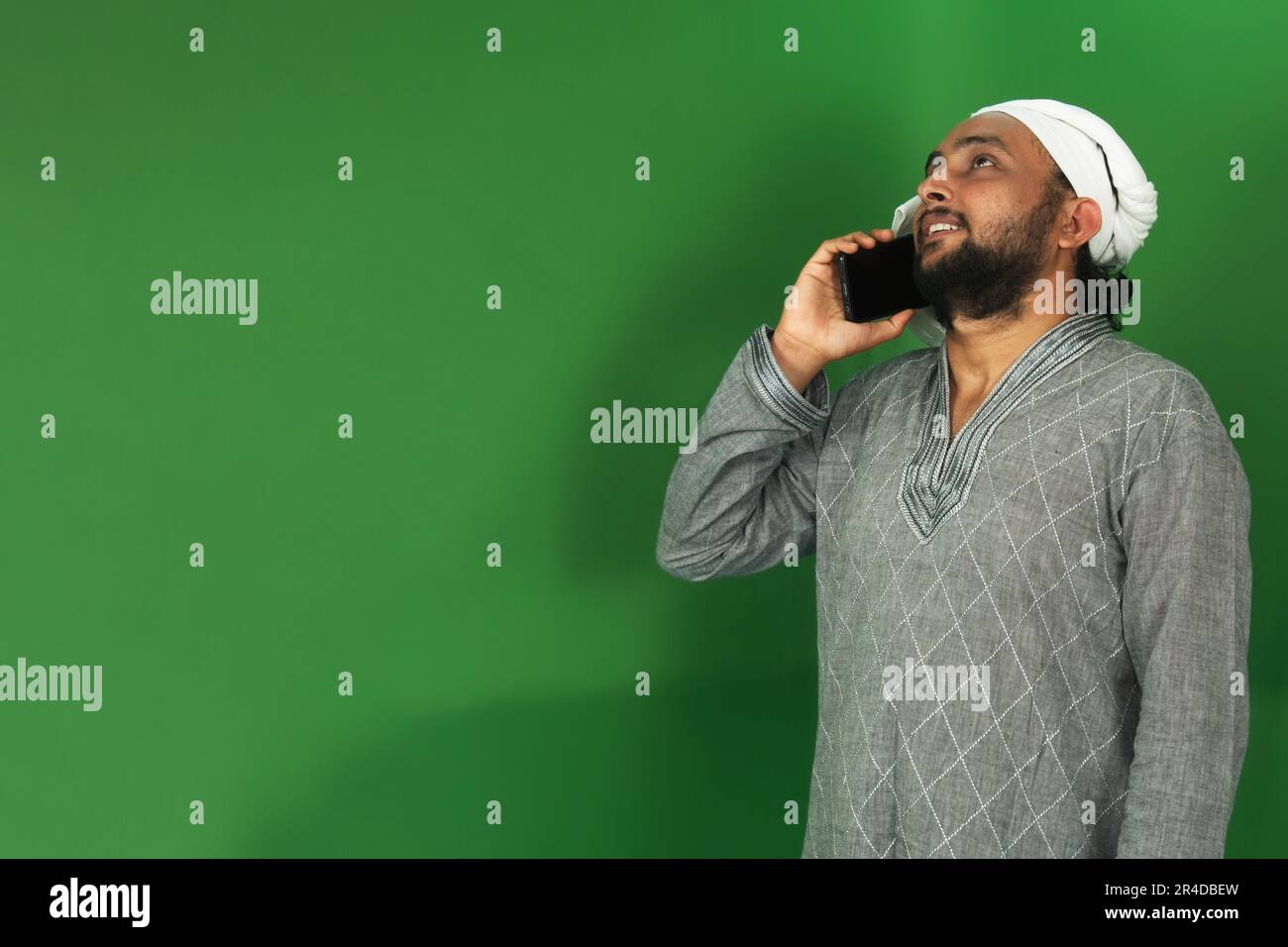 Young Indian Farmer Talking To Someone On His Mobile, Green Screen, Copy Space Stock Photo