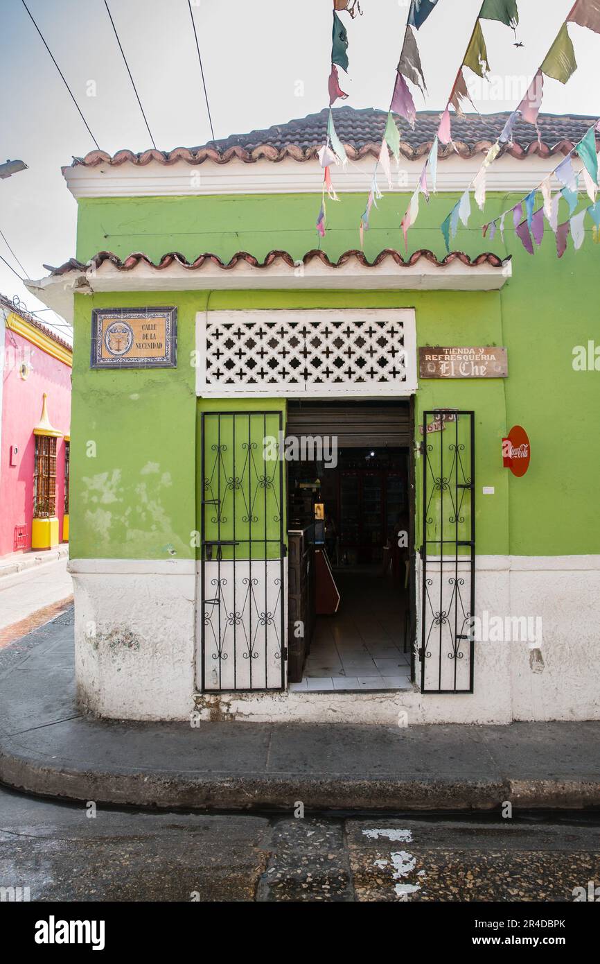 Tenants hang above a bright green building on a corner of Barrio