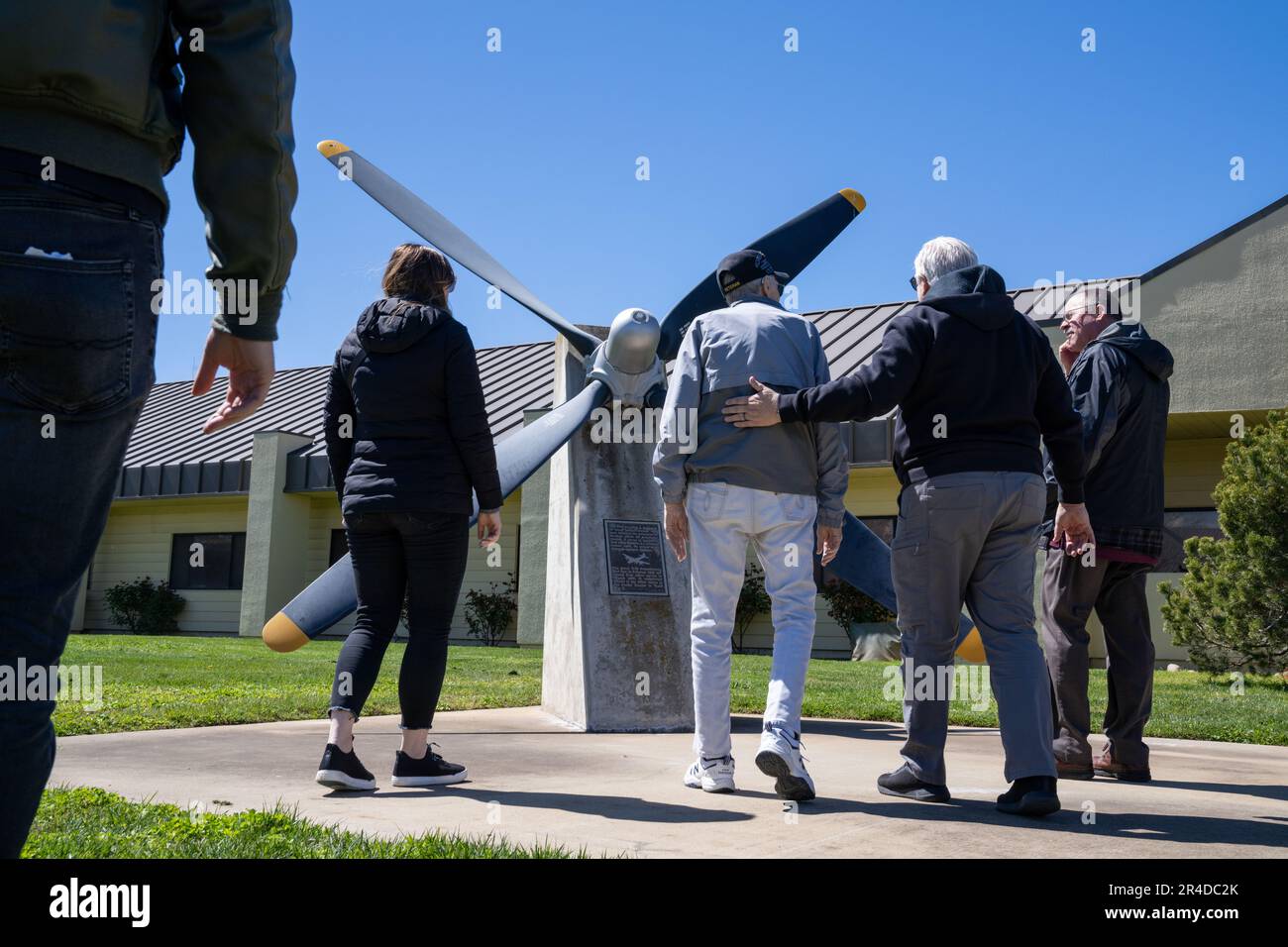 Retired Master Sgt. Eugene T. Beal and his family approach a B29