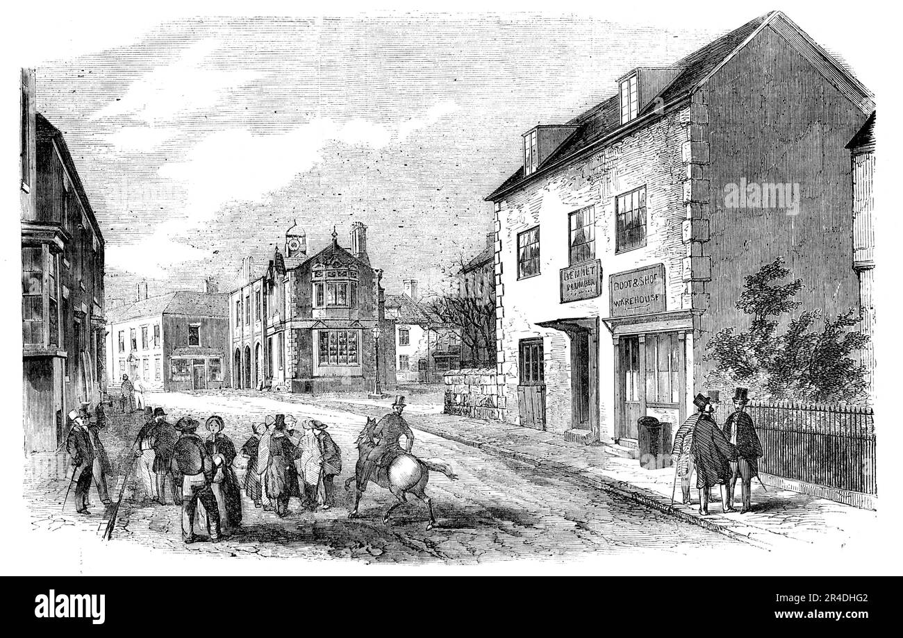 Rugeley, Staffordshire - the High-Street and Townhall, 1856. English doctor William Palmer, also known as the Rugeley Poisoner or the Prince of Poisoners, was found guilty of murder in one of the most notorious cases of the 19th century. Palmer got into debt through gambling on horse races, and took out life insurance policies on his wife and brother Walter. His friend John Parsons Cook became ill after drinking gin which Palmer had poisoned with strychnine. Palmer was arrested on the charge of murder and forgery - Palmer had been forging his mother's signature to defraud her - was tried at th Stock Photo