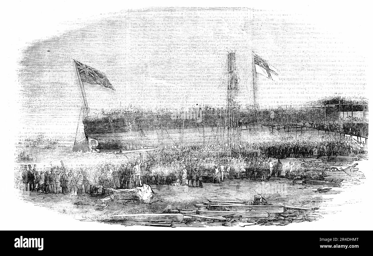 Launch of the Floating Battery &quot;Thunderbolt&quot; at Millwall, 1856. Warship at Messrs. Samuda's Works on the River Thames in London, '... the first time that a vessel entirely of iron has been built for &quot;fighting purposes&quot;...The Thunderbolt went nobly off from the slips into the waters with the greatest ease. The cheers were loud and long; and many were the good wishes and compliments to Miss Watts, the daughter of the Assistant-Surveyor of the Navy, who had the honour of naming the vessel. The Thunderbolt is 2000 tons burden, and about 186 feet in length...Outside the plating, Stock Photo