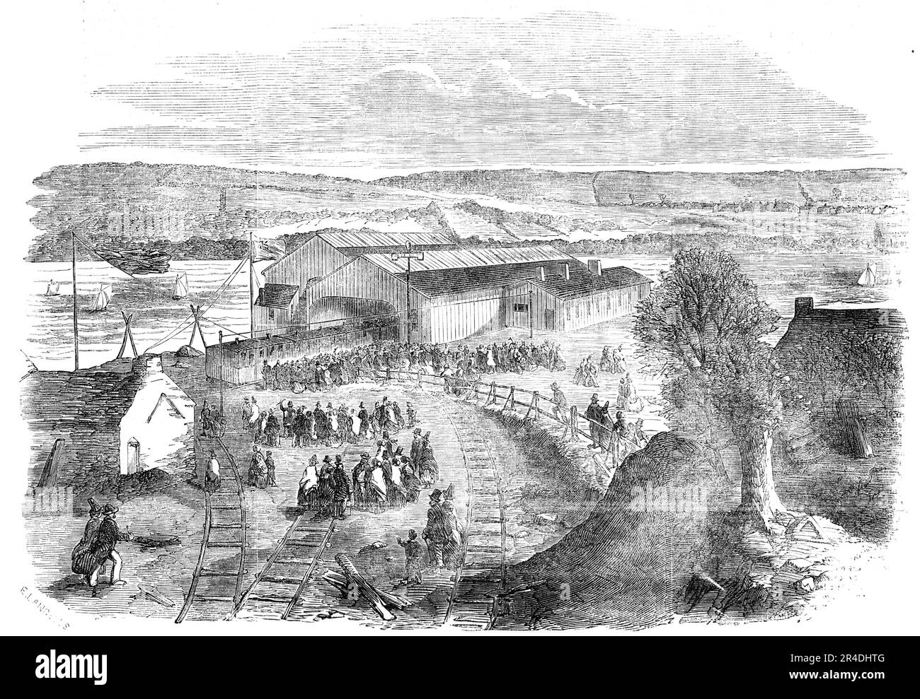 Opening of the South Wales Extension Railway, to Milford Haven, 1856. View of the Railway Terminus at Neyland, with the huts of the Montgomery, North Gloucester, and Monmouthshire Militia. 'This remote harbour, 285 miles from the metropolis, has, within the last few days, been connected therewith by railway; by means of which it may be reached in nine hours...The terminus almost faces the Royal Pembroke Dockyard...Great, indeed, will. be the importance of the South Wales Railway extension...should the expectation of its shareholders and directors prove well founded; for it is anticipated that Stock Photo