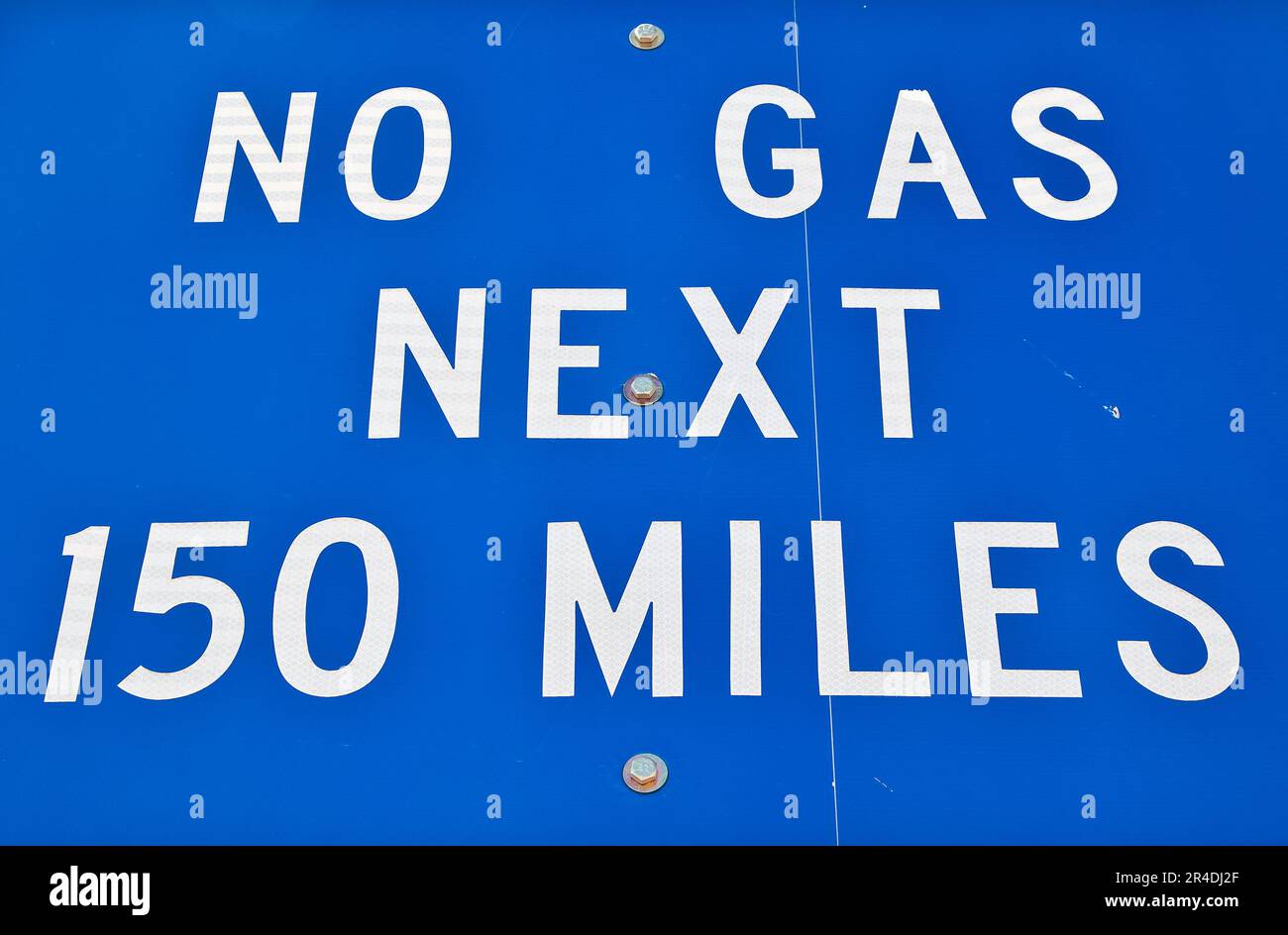 Road sign in remote desert area that reads, "No Gas Next 150 Miles