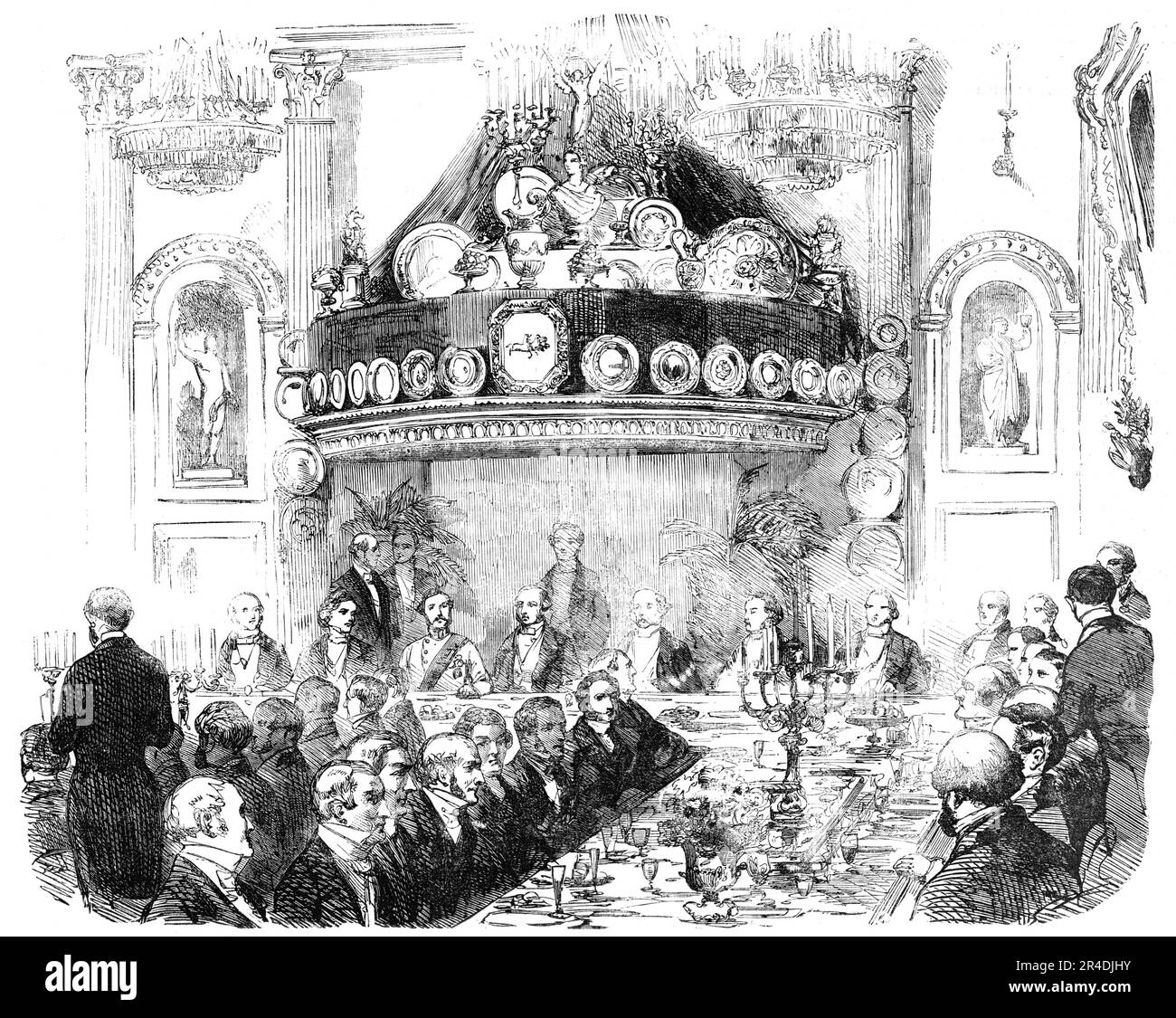 The Hon. East India Company's Banquet at the London Tavern to Lieutenant-General Patrick Grant, C.B., The New Commander-in- Chief of Madras, 1856. 'The spacious hall was magnificently decorated...The buffet called &quot;St. George's&quot; was nearly twenty feet in height, and, the background, being formed of rich crimson velvet, produced a gorgeous effect. The supporters of the Royal arms, in white and gold, were placed on each side, while on the top stood a figure of Victory holding a jewelled crown of gold over a bust of Her Majesty...the whole was brilliantly lighted up with a large number Stock Photo