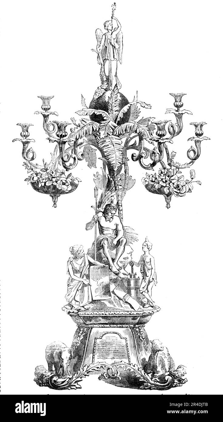 Centre-piece of the Wilcox and Anderson Services of Plate, 1856. 'This ornament is four feet in height, and has branches for nine candles and three dishes for flowers. On the...base are the camel, the elephant, and the lion. The principal group represents Enterprise, indicating on a chart the routes of the [Peninsular and Oriental Steam Navigation] company's steamers, and the Genius of Steam exhibiting to Neptune (who is seated on a rock washed by the sea) the steam cylinder and the screw as the great agents in the work. The date-palm, banana, and fan-palm rise from the base; and the crowning Stock Photo