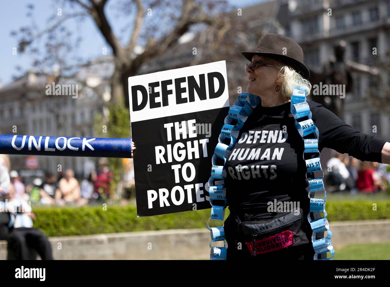 London, UK. 27th May, 2023. A protester is seen interlocking her arms with another while holding