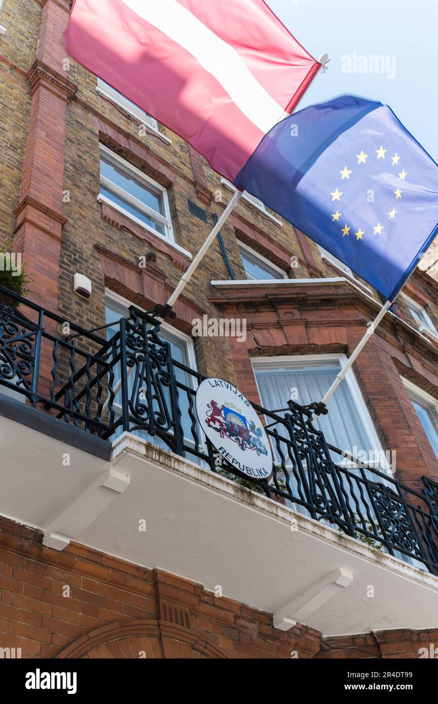 National flag and EU flag fly above the entrance to the Embassy of Latvia in Nottingham Place, Marylebone, London, England, UK Stock Photo