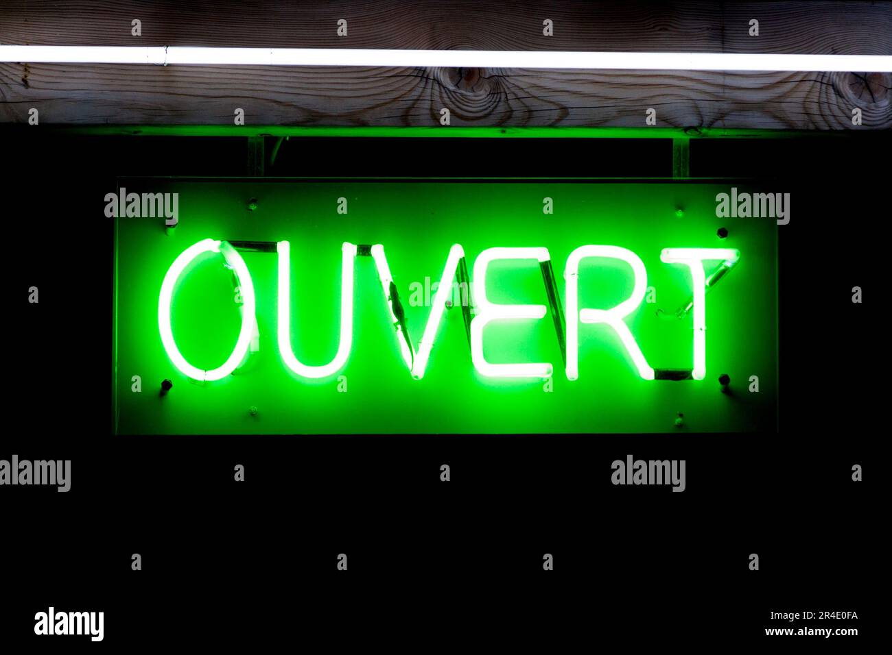 Green neon light shaped into the French word meaning OPEN in English  Stock Photo - Alamy