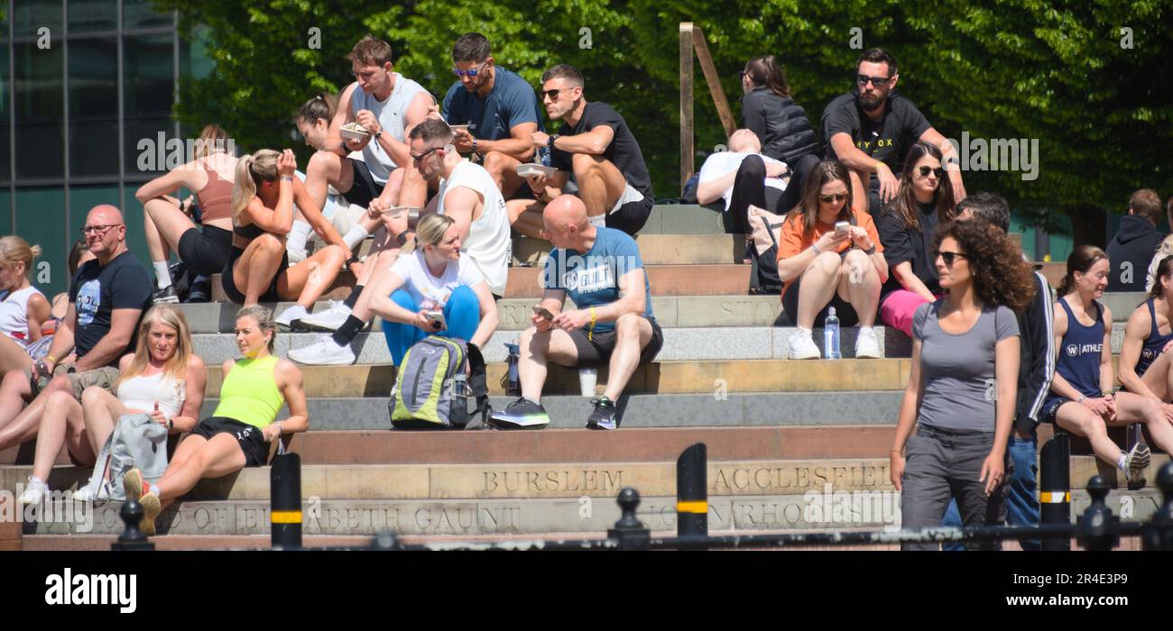 Manchester, UK, 27th May, 2023. People in Manchester, UK, sit on the Peterloo Memorial and enjoy the Bank Holiday weekend. Credit: Terry Waller/Alamy Live News Stock Photo