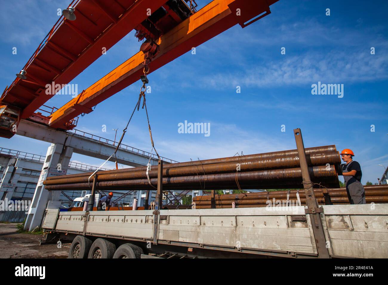 Podolsk, Moscow province - August 02, 2021: Pipes warehouse. Loading pipes with overhead crane. Stock Photo