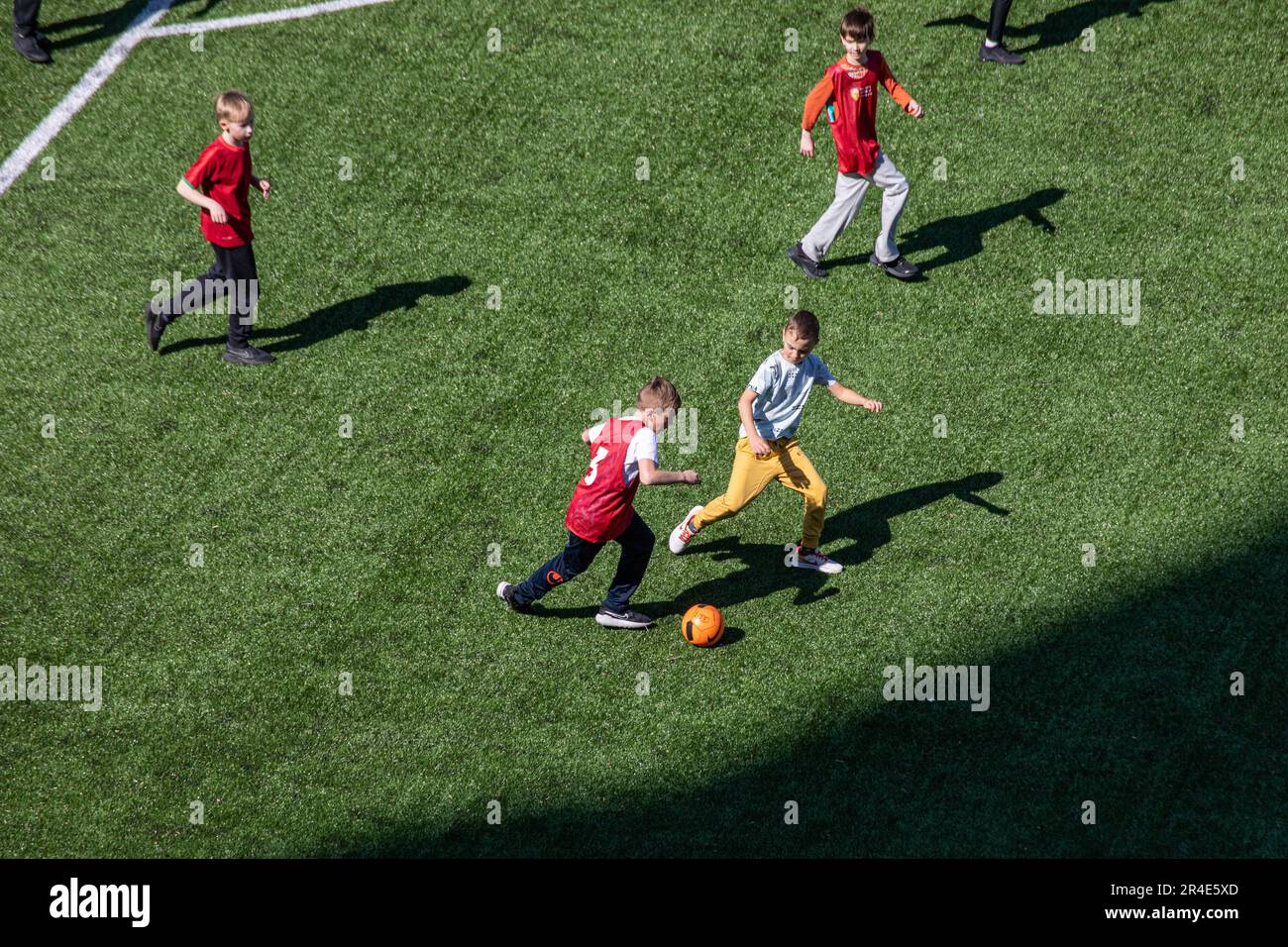 High-angle view of school boys playing football on artificial turf at Snelli Staadion in Tallinn, Estonia Stock Photo