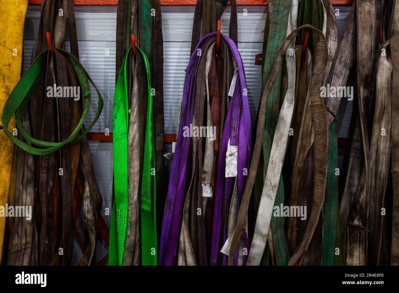 Metalworks plant. Dirty color weight lifting belts Stock Photo