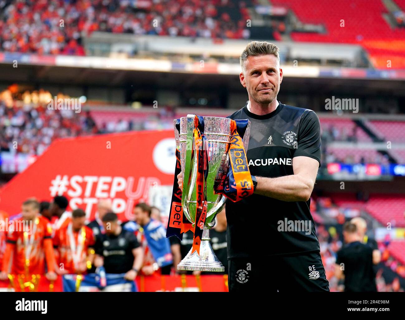 Luton Town manager Rob Edwards poses for a photo with the trophy after