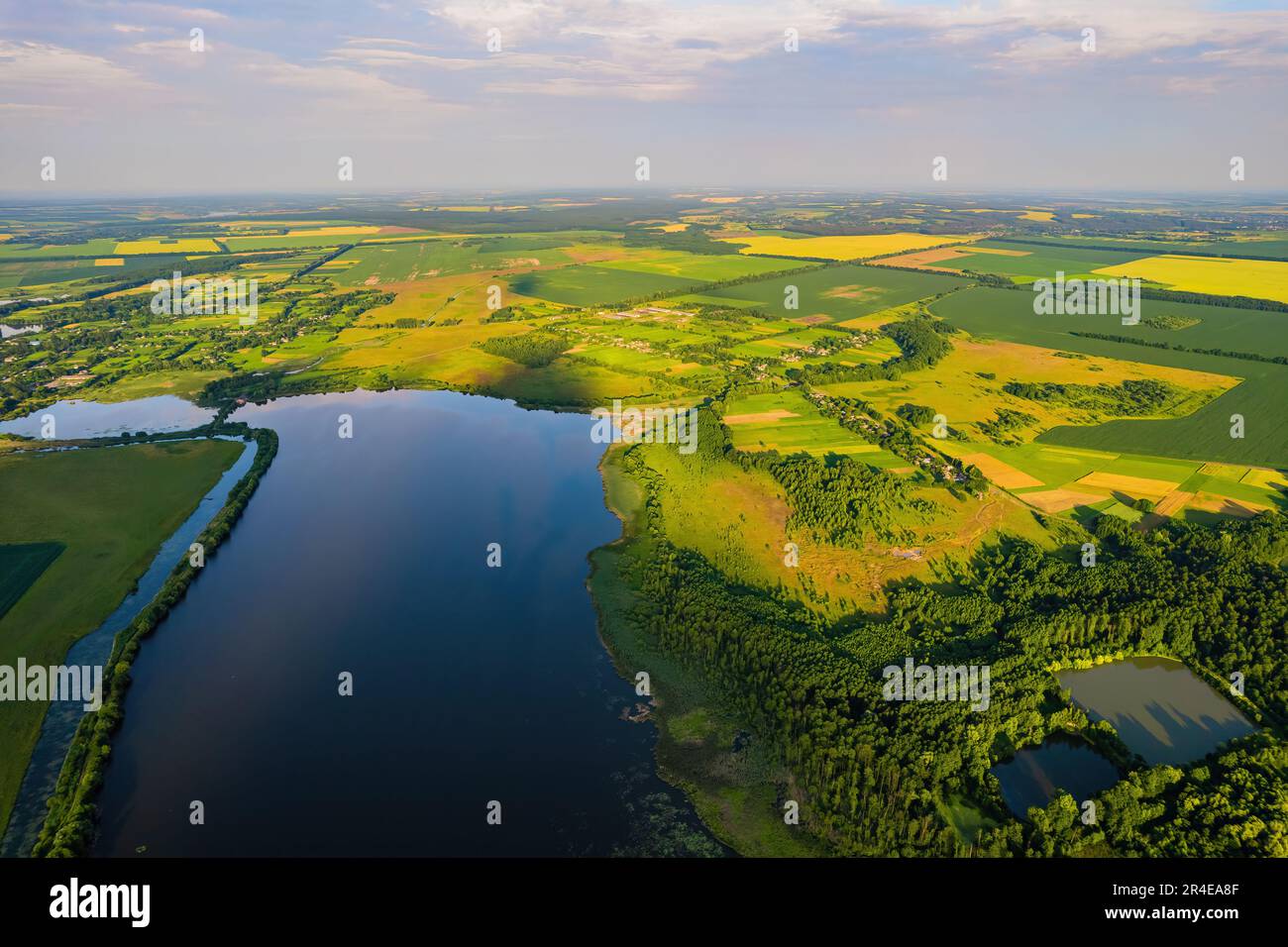 Top view drone shot of a green field and river Stock Photo - Alamy
