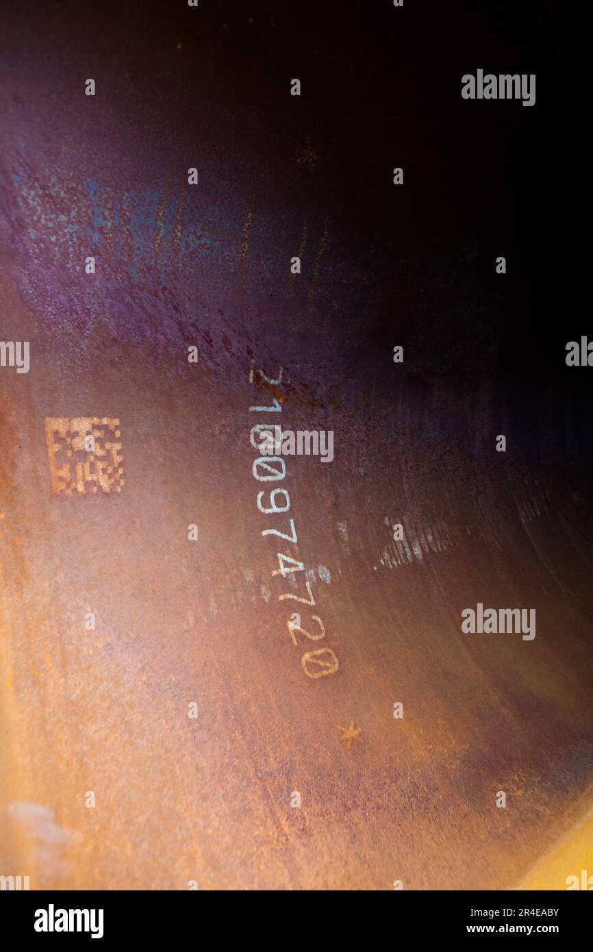 Marking of steel tube. Closeup photo of printed QRcode and numbers on