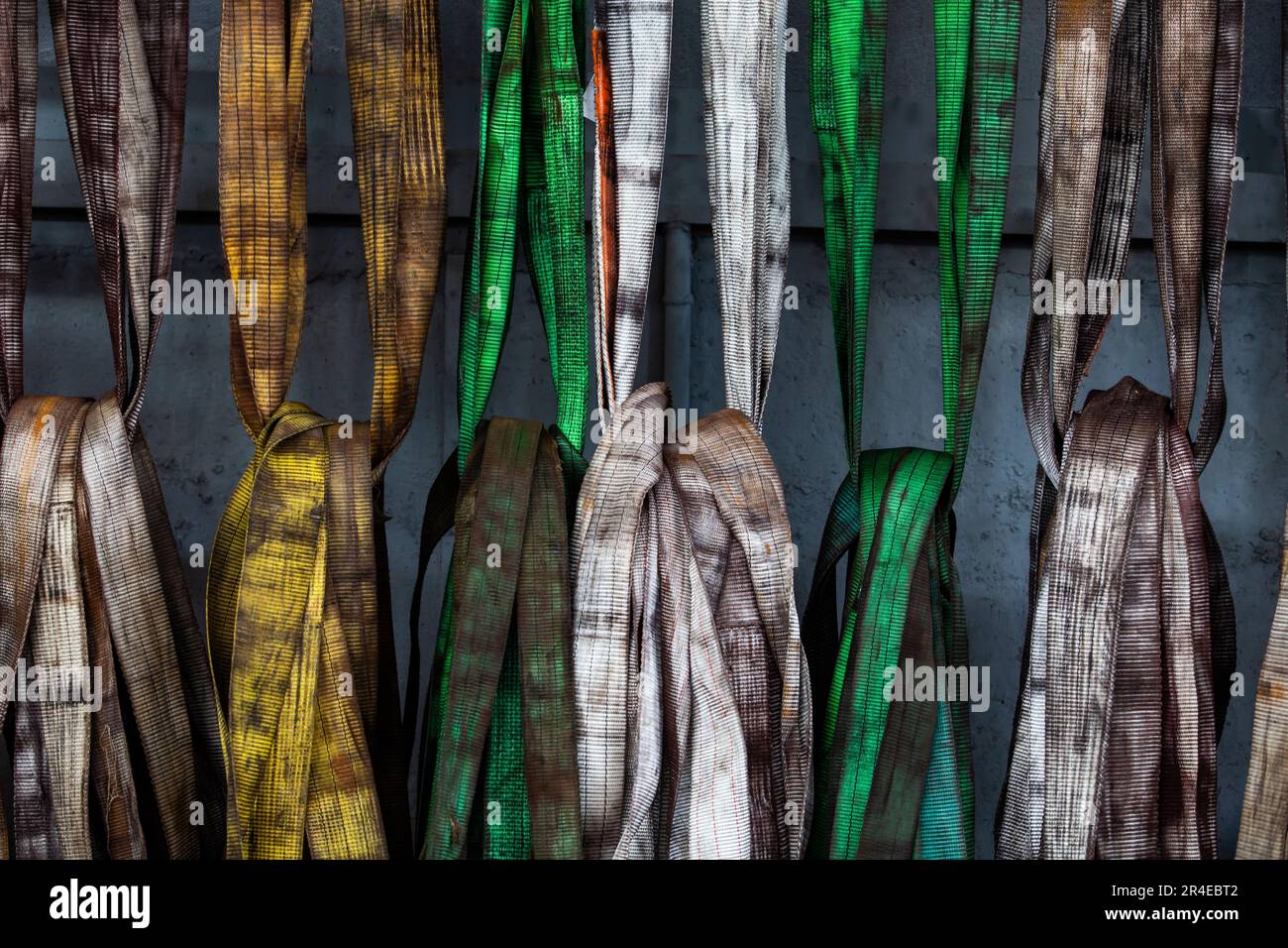 Weight lifting straps on metalworks plant. Stock Photo