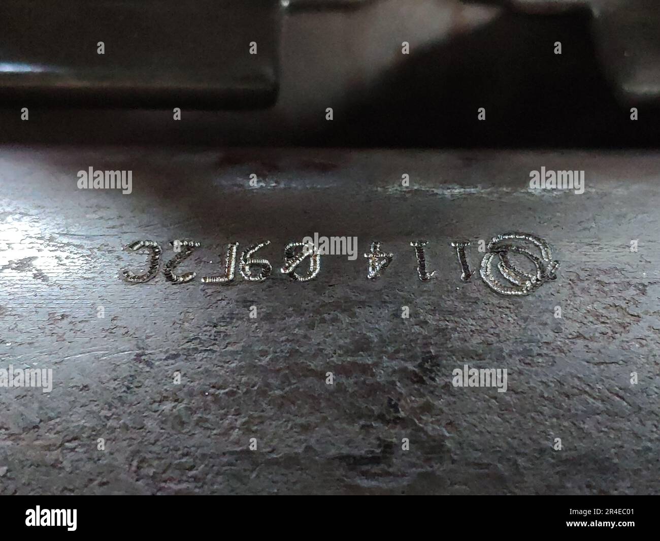 Marking on steel with dot impact machine. Dark and closeup photo Stock Photo
