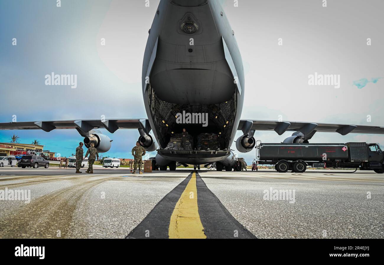 Airmen assigned to the 734th Air Mobility Squadron assist with cargo of Federal Emergency Management Agency personnel on Andersen Air Force Base, Guam, 26 May, 2023.  FEMA personnel arrived to Guam to assist with Typhoon Mawar relief efforts. Typhoon Mawar was a Category 4 storm, producing winds of at least 130 mph (209 km) making it one of the stronger typhoons to hit Guam in decades. (U.S. Air Force photo by Staff Sgt. Divine Cox) Stock Photo