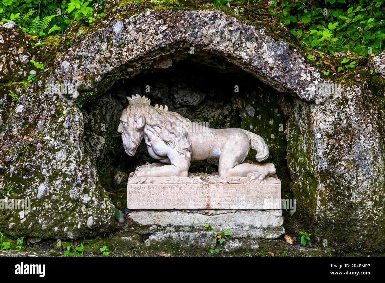 The Forest Devil at Hellbrunn Palace in Salzburg (Austria) is a four-legged forest man walking on his knees and elbows, with a bearded human head with a cockscomb, as well as lion-like front feet and a bushy tail. The hind feet are shaped in the manner of bird feet Stock Photo