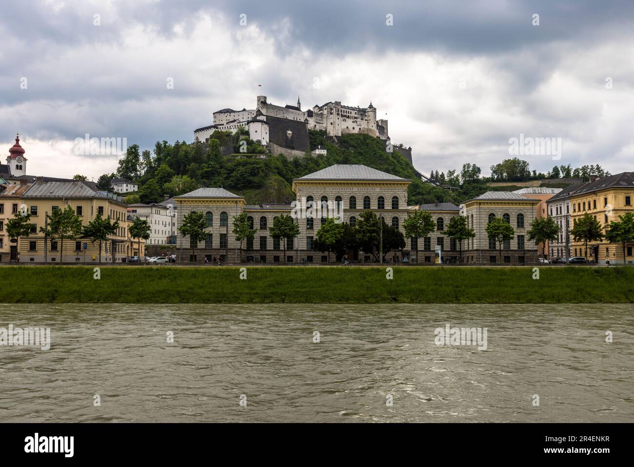 University and the fortress Hohensalzburg beyond the river Salzach in Salzburg, Austria Stock Photo