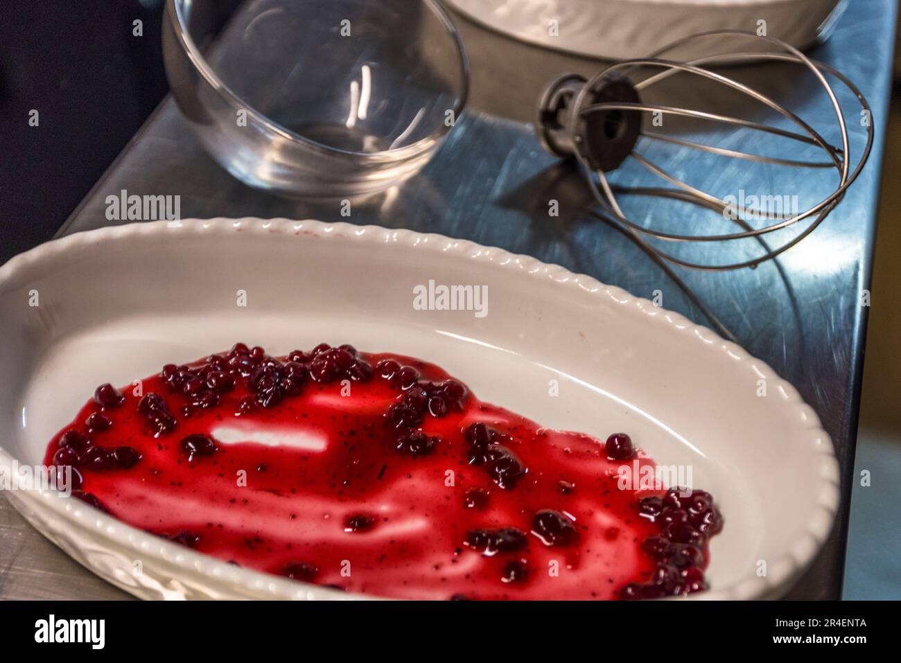 Salzburger Nockerln are a sweet affair from the very beginning. The bottom of the mold is spread with cranberry compote. Salzburg, Austria Stock Photo
