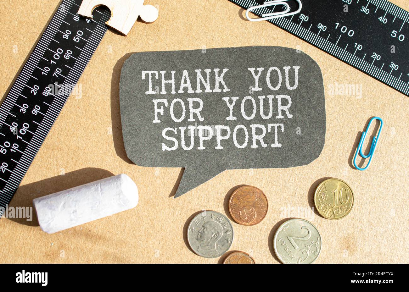 handwriting text thank you for your support is written in chalkboard on green light background and rustic wooden board, close up Stock Photo