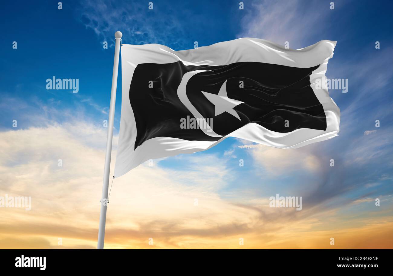 official flag of Terengganu Malaysia at cloudy sky background on sunset, panoramic view. Malaysian travel and patriot concept. copy space for wide ban Stock Photo