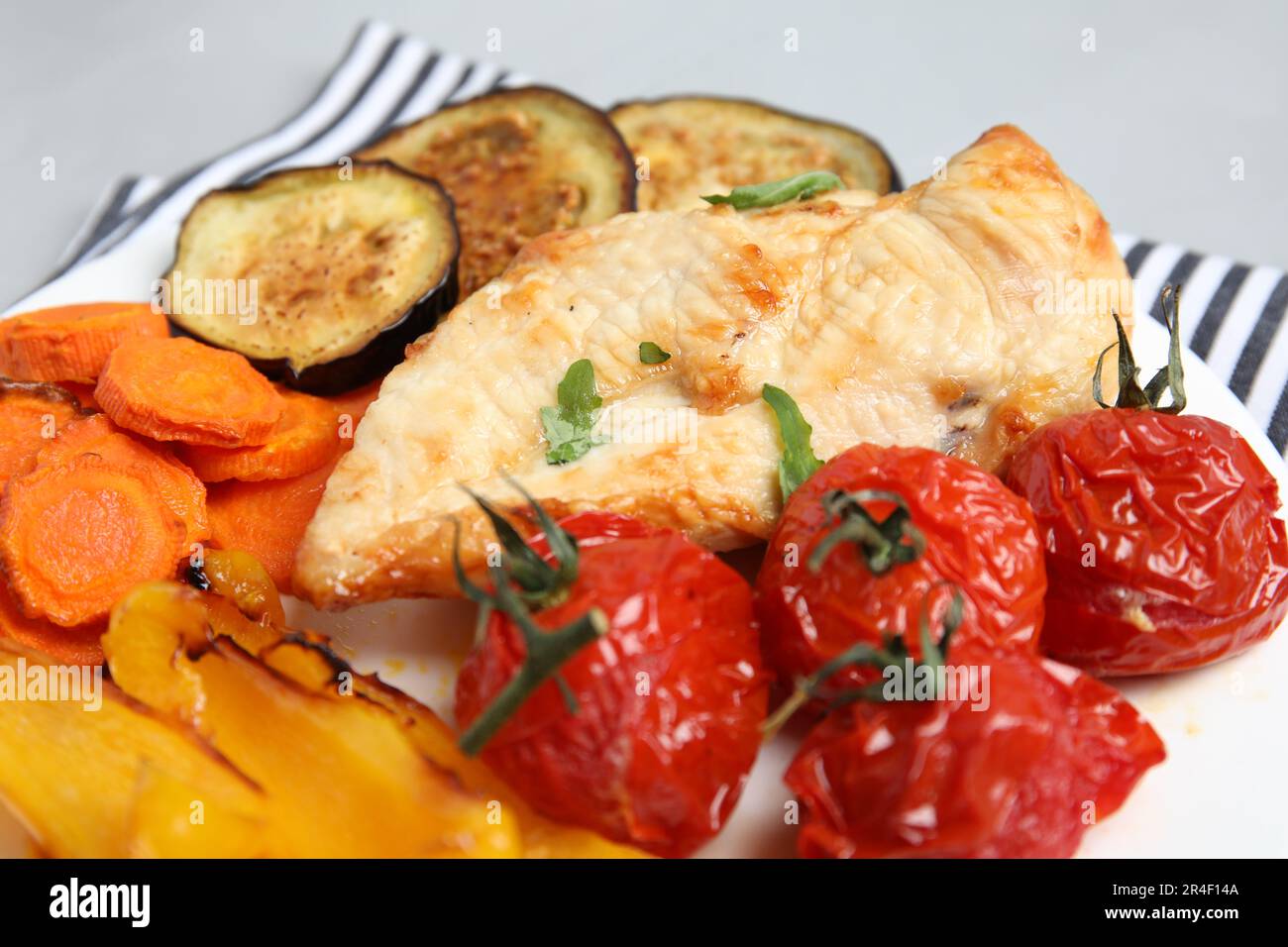 Delicious cooked chicken and vegetables on plate, closeup. Healthy