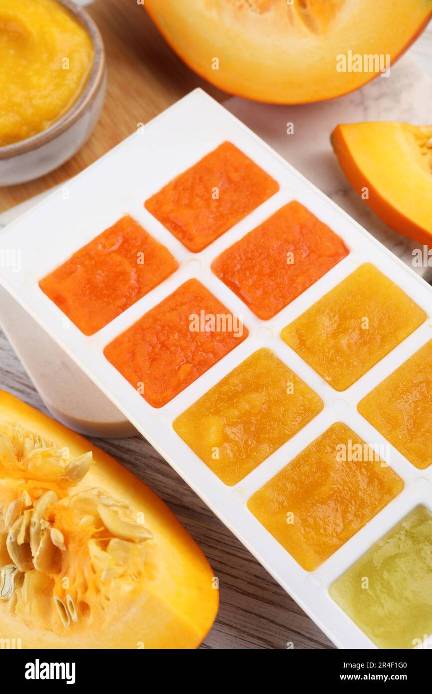 Different purees in ice cube tray ready for freezing and fresh pumpkin