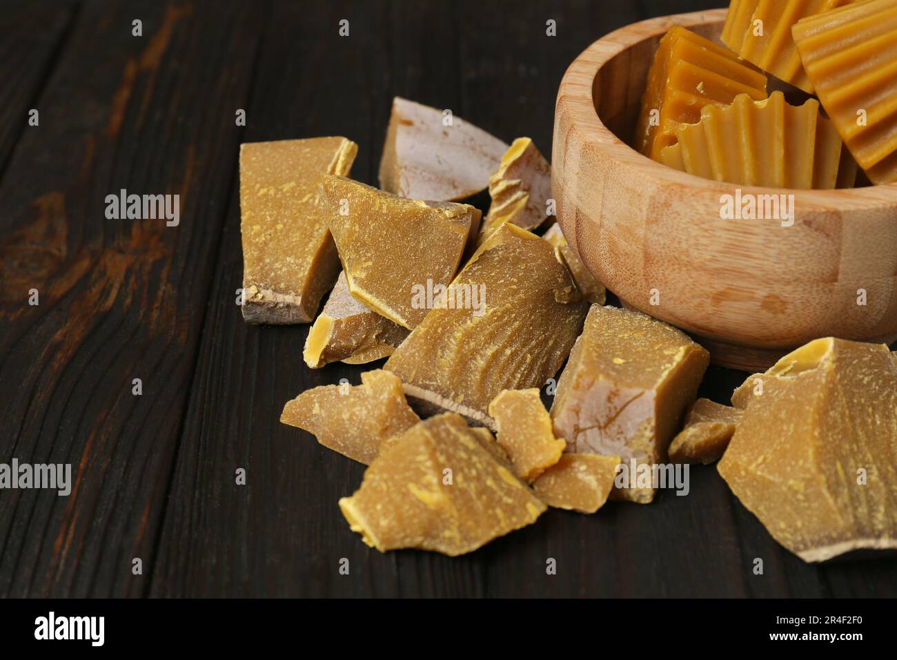 Different natural beeswax blocks on wooden table. Space for text Stock Photo