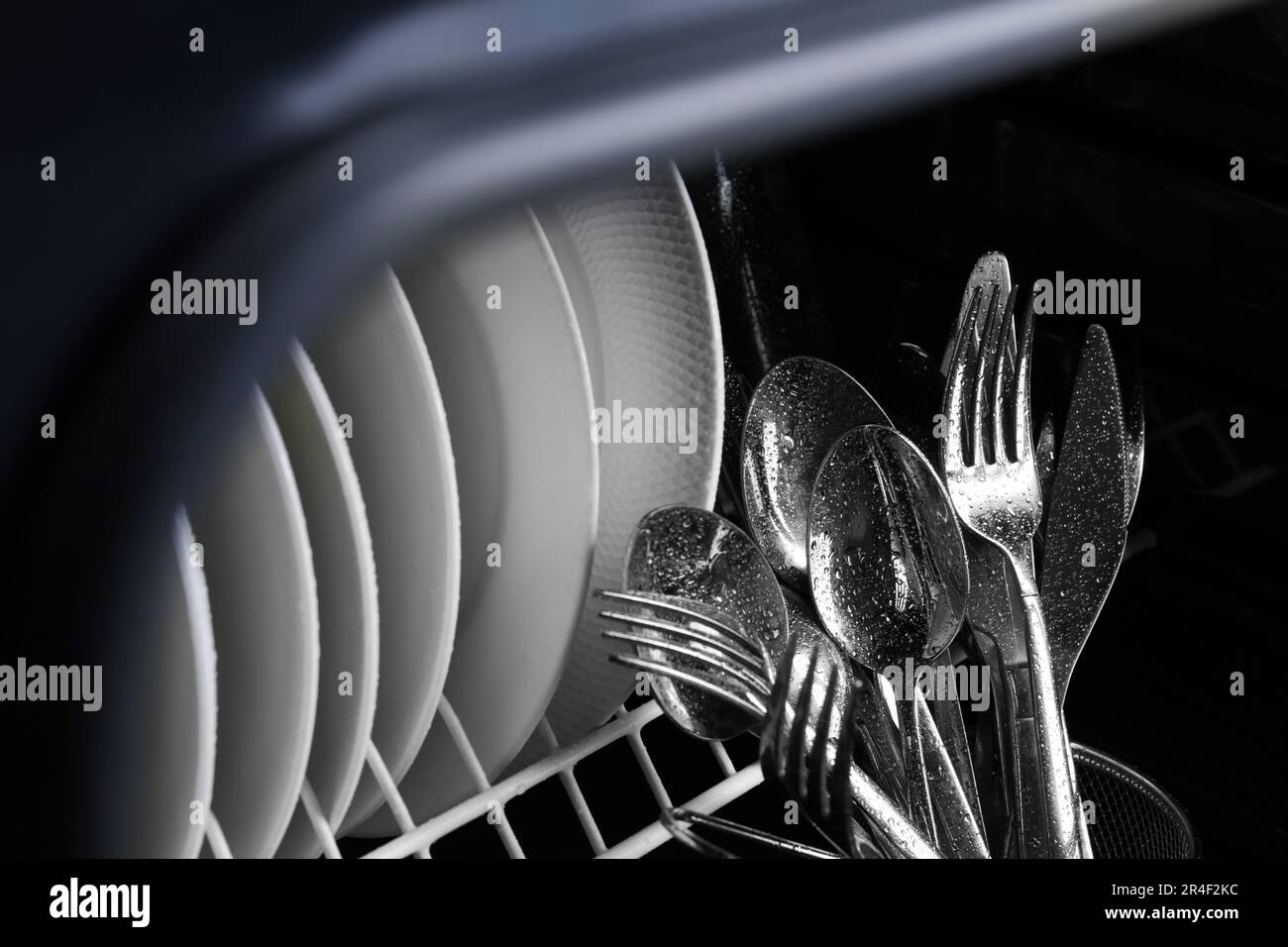 Clean wet plates and cutlery in dishwasher, closeup Stock Photo Alamy