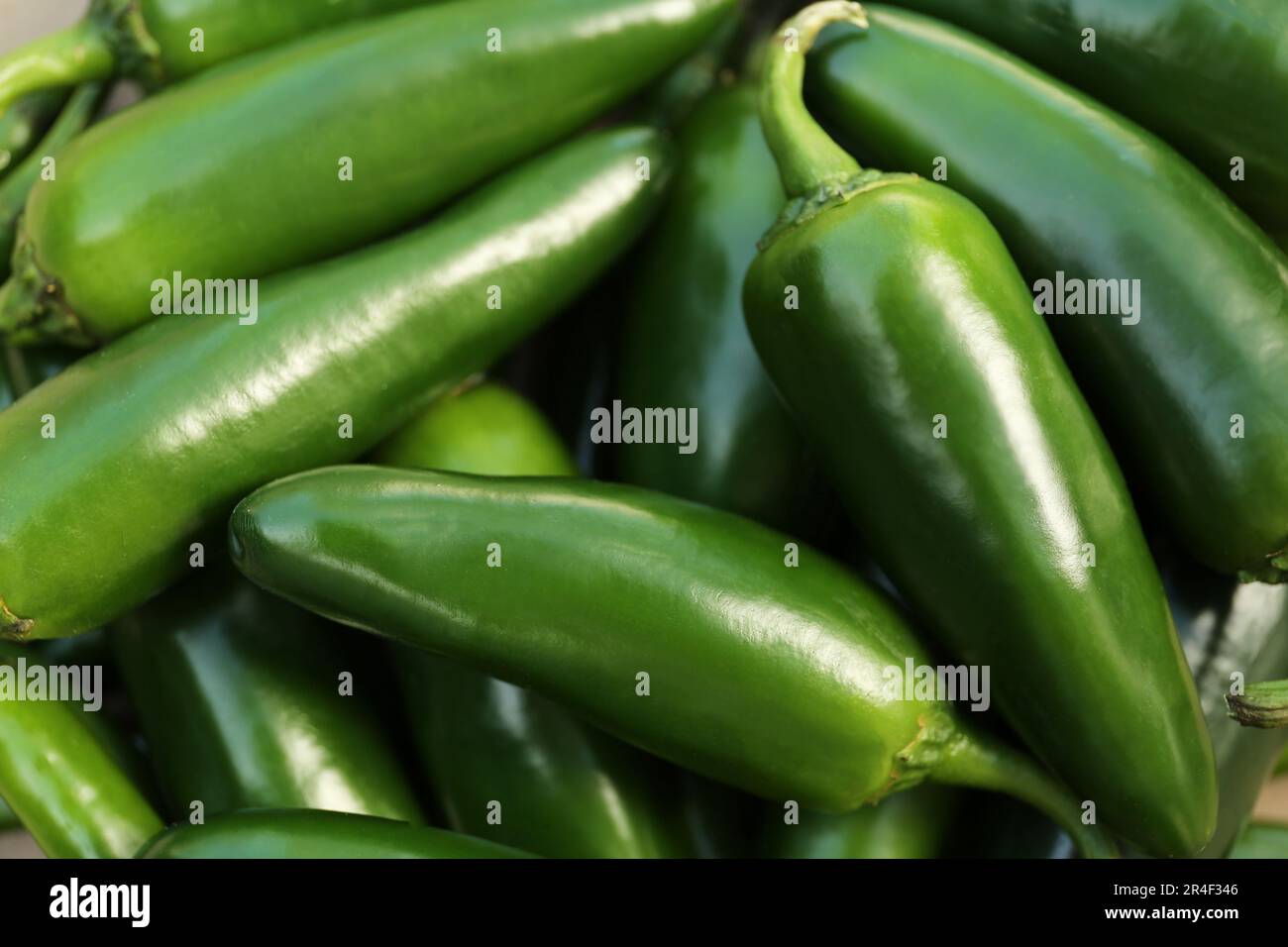 Green hot chili peppers as background, closeup Stock Photo - Alamy
