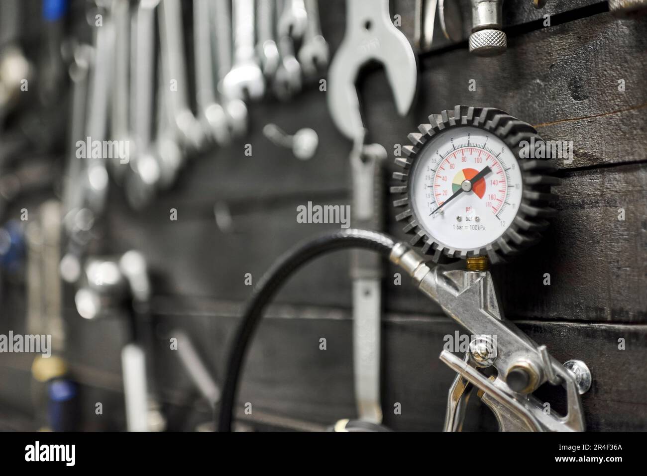 Pressure gauge and other tools on a board hanging on the wall of a