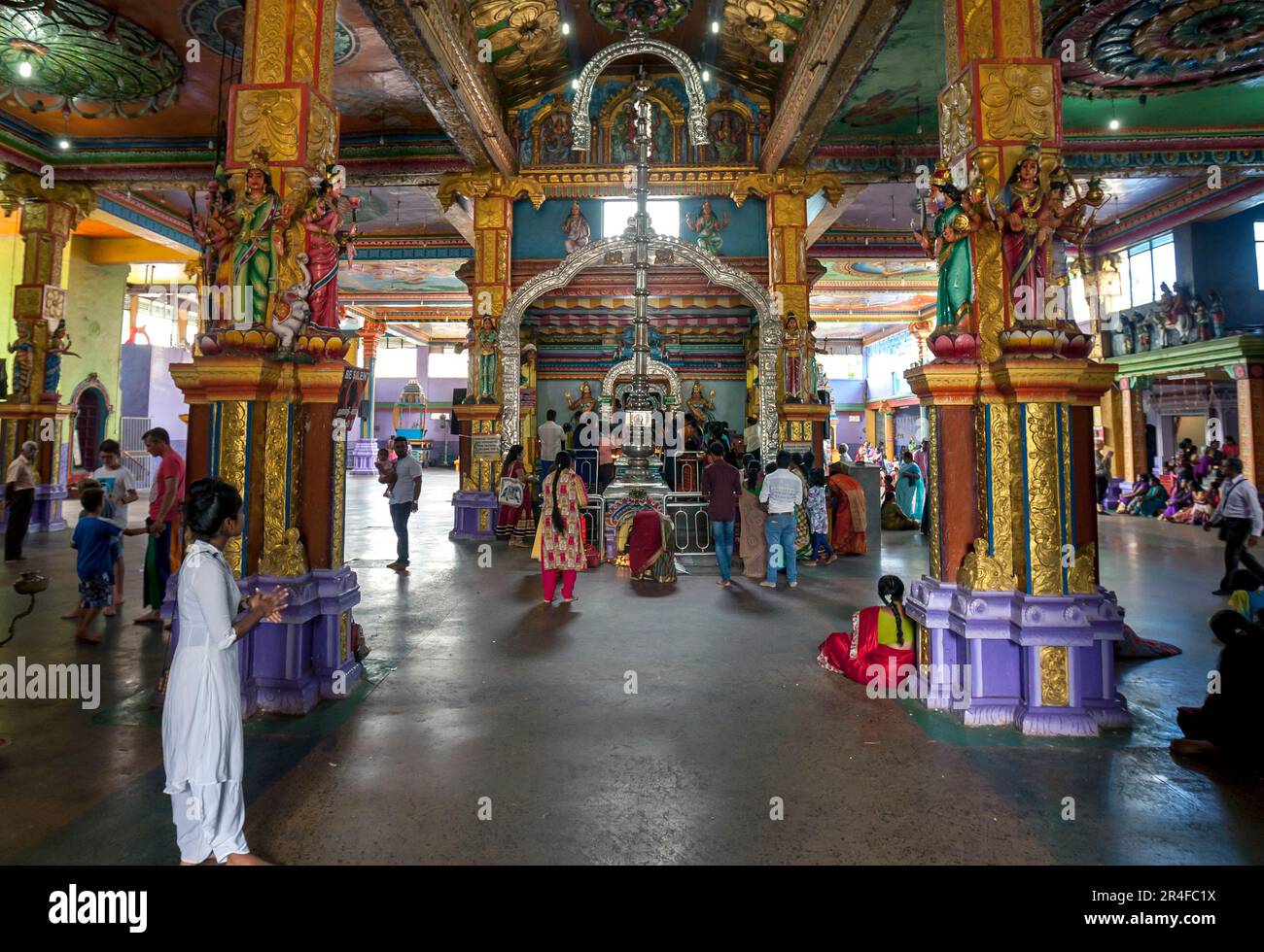 Worshippers gathered at the shrine room within Sri Muthumariamman Thevasthanam Hindu Temple at Matale in Sri Lanka. Stock Photo