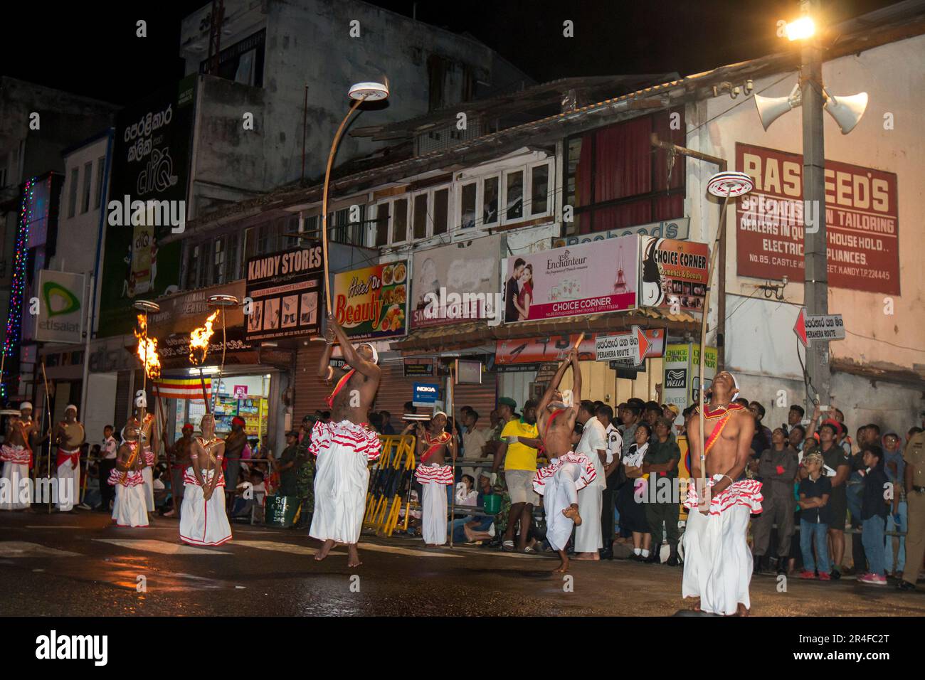 Tambourine Dancers or Rabun Nettuwo perform along a street during the Buddhist Esala Perahera at Kandy in Sri Lanka. Stock Photo