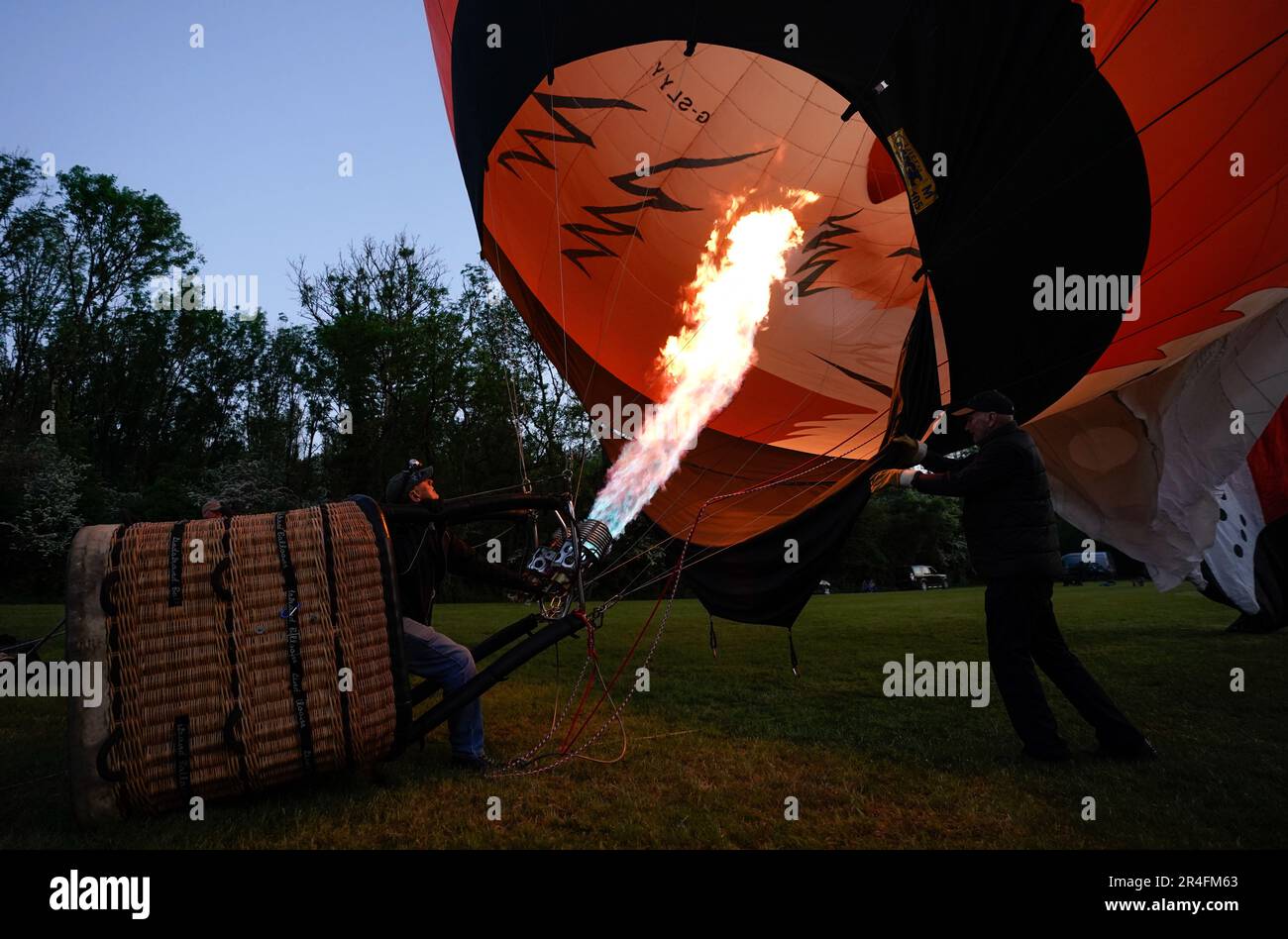 A hot air balloon crew prepare their balloon to take part in a night