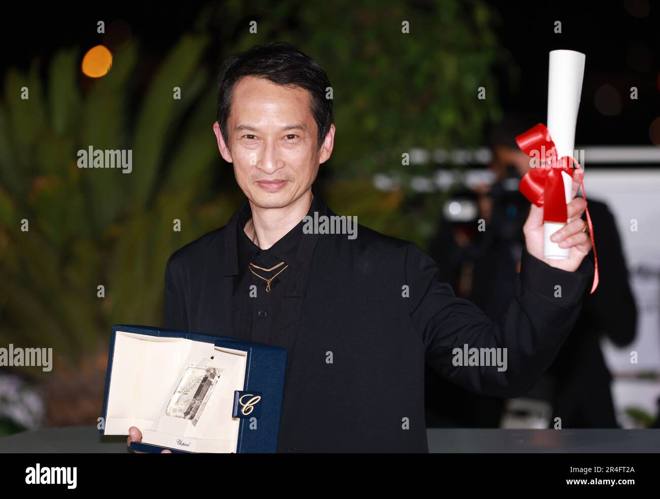Cannes, France. 27th May, 2023. VietnameseFrench director Tran Anh Hung poses with the trophy Cannes, France. 27th May, 2023. VietnameseFrench director Tran Anh Hung poses with the trophy