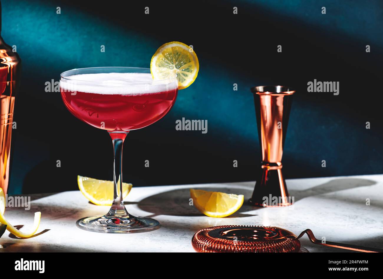 Pink lady classic cocktail drink with dry gin, grenadine syrup, lemon