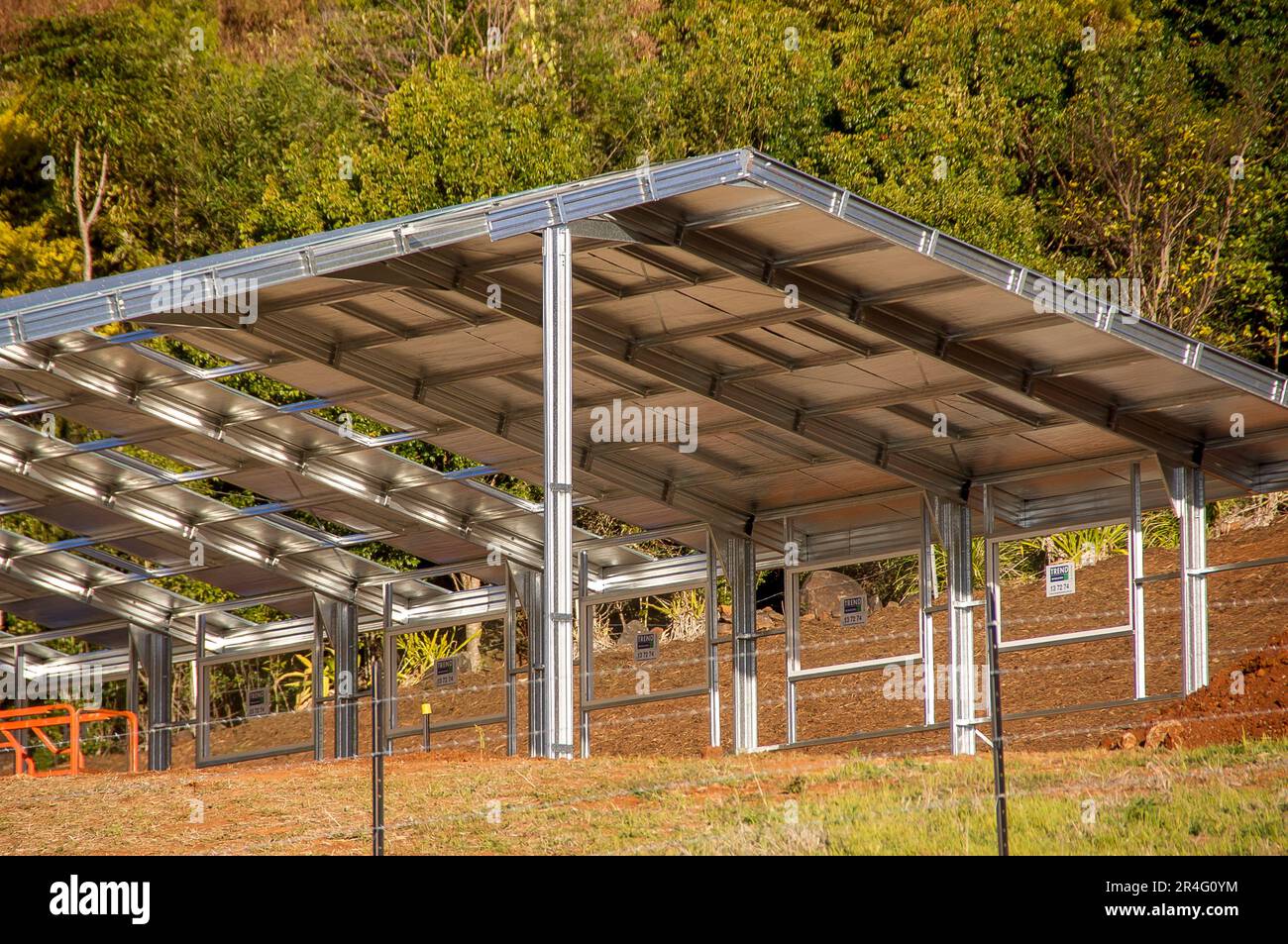 Large steel-framed shed under construction in rural Queensland, Australia. Partially built. No walls. Shiny steel. Stock Photo