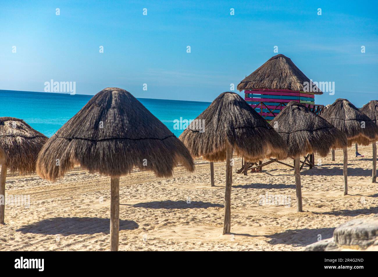 Watchtower of beach watchmen in the Caribbean with lines of umbrellas. Sea watchtower and bathers on a caribbean beach. Beach concept summer vacations Stock Photo