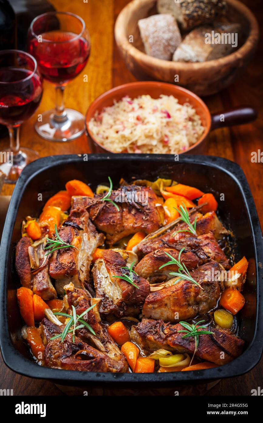 Roasted pork belly on vegetables with sauerkraut and red wine Stock