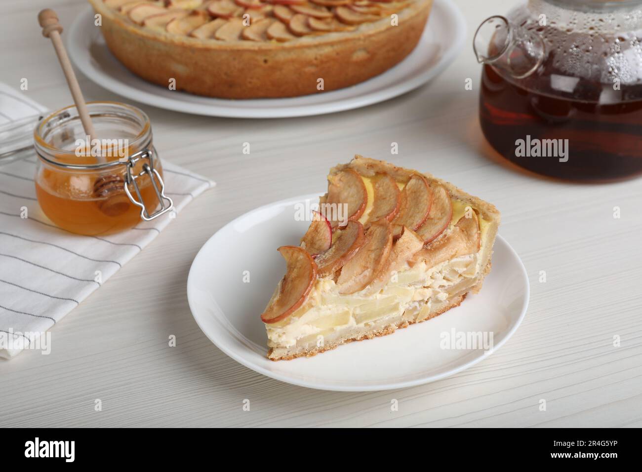 Piece of delicious homemade apple pie served on white wooden table Stock Photo