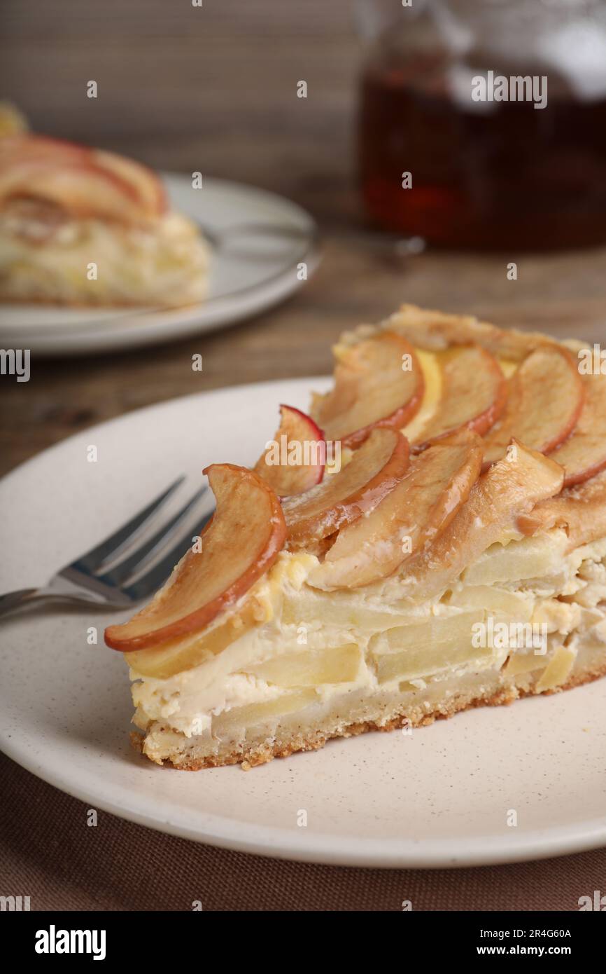 Piece of delicious homemade apple pie on wooden table, closeup Stock Photo